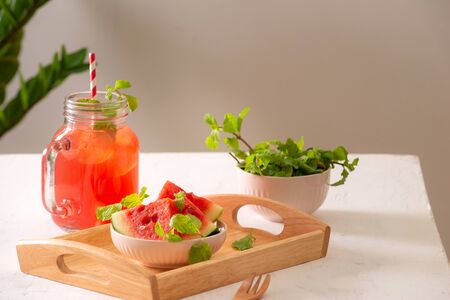 Watermelon drink in glass with slices of watermelon on whitebackgroundの写真素材