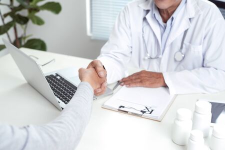 Senior doctor consults young patient
