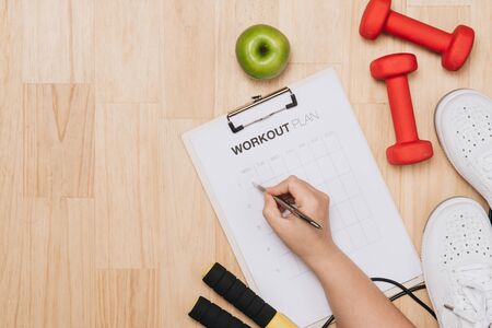 Dumbbells, bottle of water and skipping rope on blue background. Top view. Fitness, sport and healthy lifestyle concept.の写真素材
