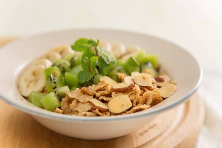 Healthy breakfast: corn flakes with milk and fresh fruits