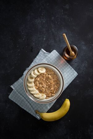 Bowl of corn flakes with banana an honeyの写真素材