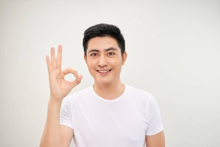 portrait of an asian man doing the okay gestureの写真素材