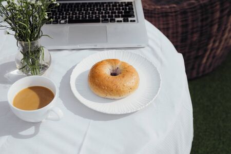 Laptop, bread and cafe in coffee shopの写真素材