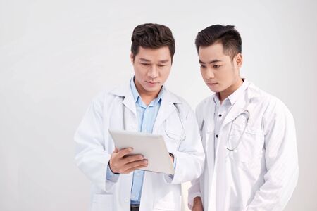 Two man doctor looking at the ipad/tablet and having a discussionの写真素材