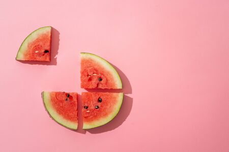 Sliced watermelon on the pink background