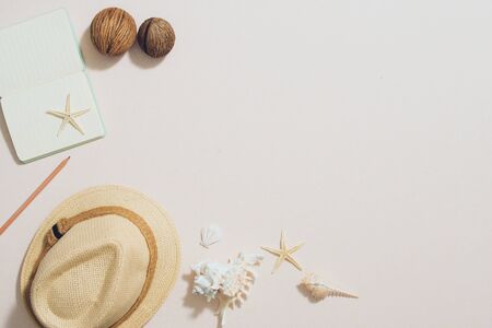 Colorful summer holidays fashion flat lay - straw hat, camera, sunglasses, sea shells on ligh backgroundの写真素材