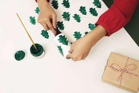 Woman making Christmas paper present / gift. Noel, xmas concept