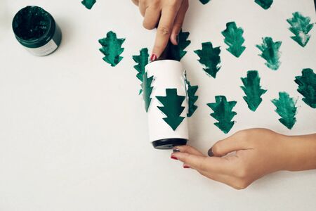 Close up of female hands making present paper cover. Xmas conceptの写真素材