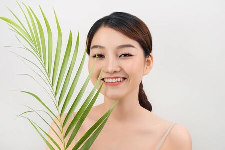 Beautiful woman of Asian appearance palm leaf nature skin careの写真素材