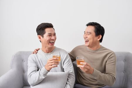 Men talk concept. Two young male friend gathering, chatting and eating at home.の写真素材