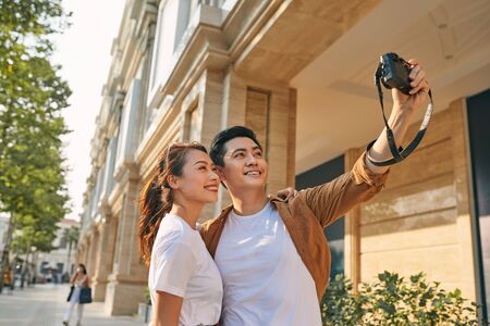 Happy tourists taking photo of themselvesの写真素材