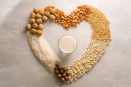 Glasses of milk with nuts: Macadamia, almond, soy, rice, lotus. Top view.の写真素材