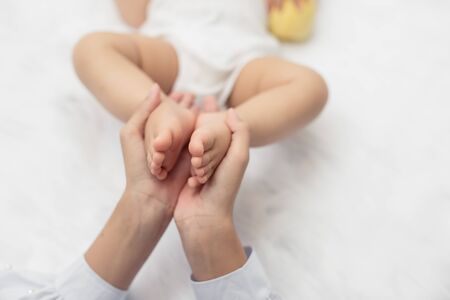 Baby feet in mother hands. Mom and her Child. Happy Family concept.の写真素材