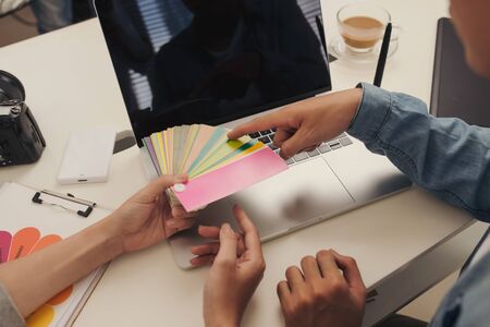 Graphic designer at work. Color swatch samples.