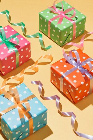 Collection of Christmas present boxes on a light yellow backgroundの写真素材