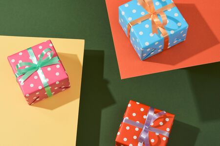Christmas gift boxes with ribbons on color tabletop