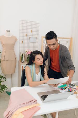 Two fashion designers working together on a deskの写真素材