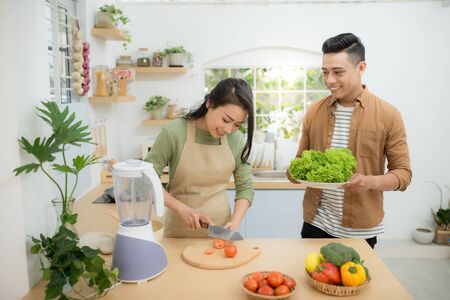 Attractive couple is cooking on kitchen.の写真素材