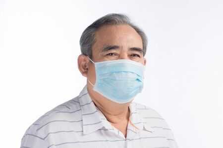 Asian senior man wearing face mask isolated on white background, selective focus.の写真素材