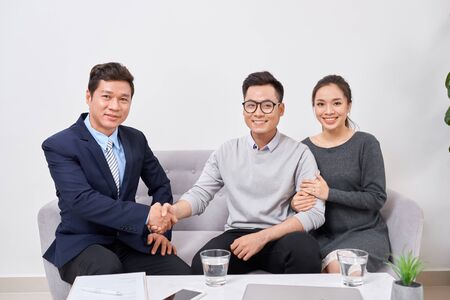 Real estate agent working with clients in officeの写真素材