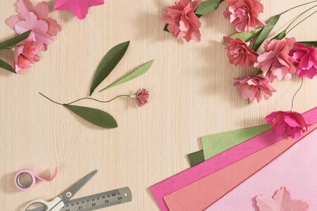 Flowers composition. Scissors, ruler and pink flowers on wood background. Flat lay, top view, square.の写真素材