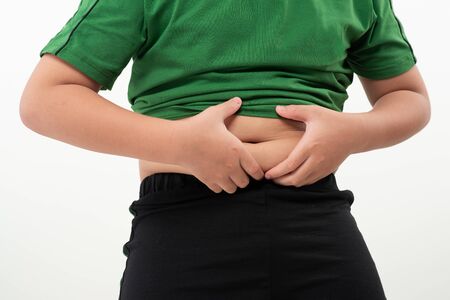Asian little boy with stomach ache, child holding his hands on his belly. Stomach ache child stock image.の写真素材