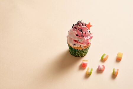 Cupcake, confetti background with copy space.
