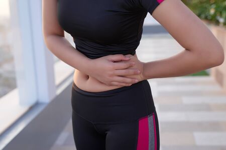 Muscular woman with stomach pain