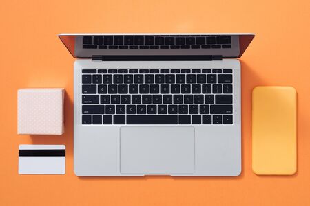 Flat lay minimalist composition for gift wrapping and internet shopping on color background