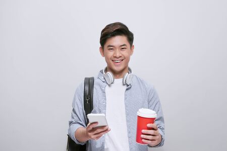 handsome young man write sms and drink coffeeの写真素材