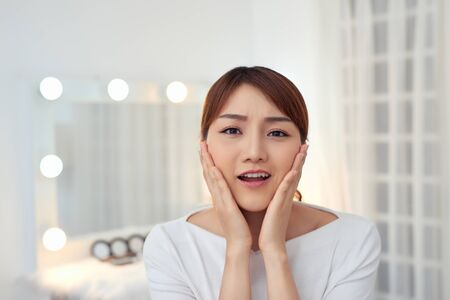 Portrait of beautiful woman with natural make up touching her face. Beauty young woman with fresh clean perfect skin.の写真素材