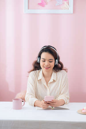 Young asian casual businesswoman listening music