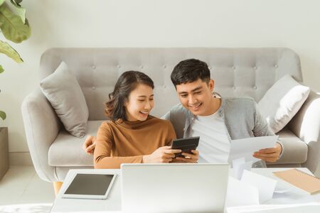 Young Asian man and woman stress with her business online shopping at office.の写真素材