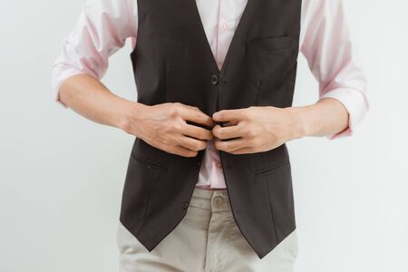 Asian businessman button his suit, get ready for work.の写真素材