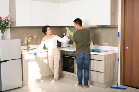 Young family couple doing cleaning in the house. Cleaning concept.の写真素材