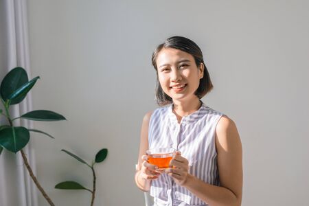 Young asian girl feeling happy with her cupの写真素材