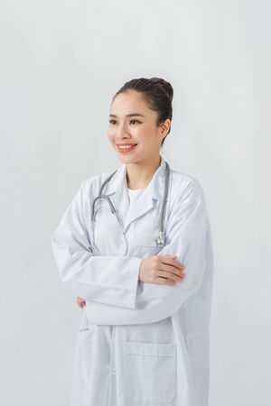 Confident young woman doctor  standing arms crossedの写真素材