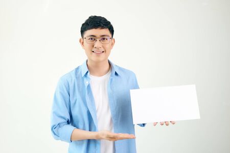 Asian young man showing pannel isolated on white background.の写真素材