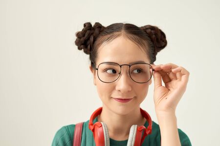 Young Asian woman wear eyeglasses beautiful student with bag.の写真素材