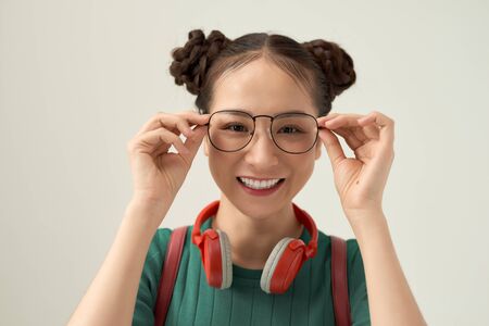 Portrait of her she nice cute sweet lovely attractive cheerful cheery  touching fixing glasses isolated over whiteの写真素材