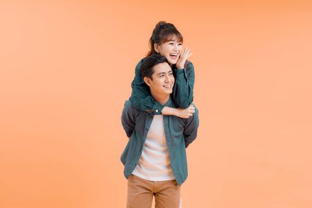 Handsome man giving piggy back to his girlfriend の写真素材