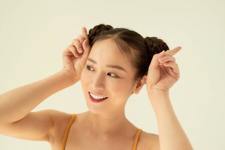 Close up portrait of beautiful, attractive, pretty, dreamy girl raised hands up isolated on light background.の写真素材