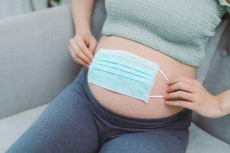 asian pregnancy woman using medical mask for protection Covid-19 or Coronavirus infection