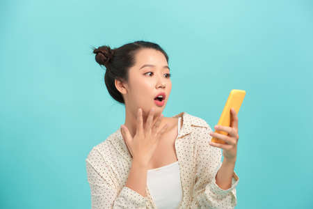 Exited girl is shocked because of a surprising messageの写真素材