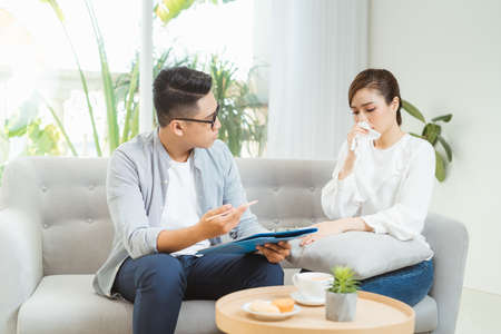 Psychological treatment. Professional psychologist helping his patient while having a session with him.の写真素材