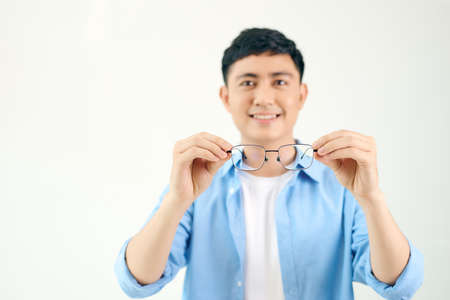 cheerful man holding glasses in front of him on a white backgroundの写真素材