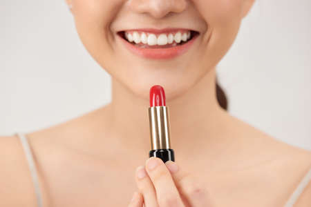 Woman applying lipstick, closeupの写真素材