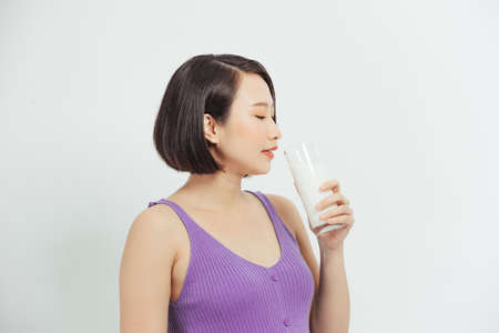 The pregnant girl drinks milk. isolated on white background