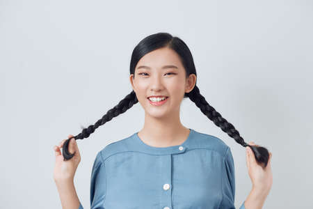 Young cheerful girl having fun. Smiling Woman with bright makeup and hairstyle with pigtails