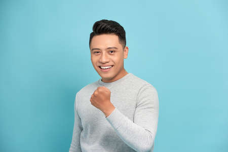 excited man cheering with clenched fists Isolated On Whiteの写真素材